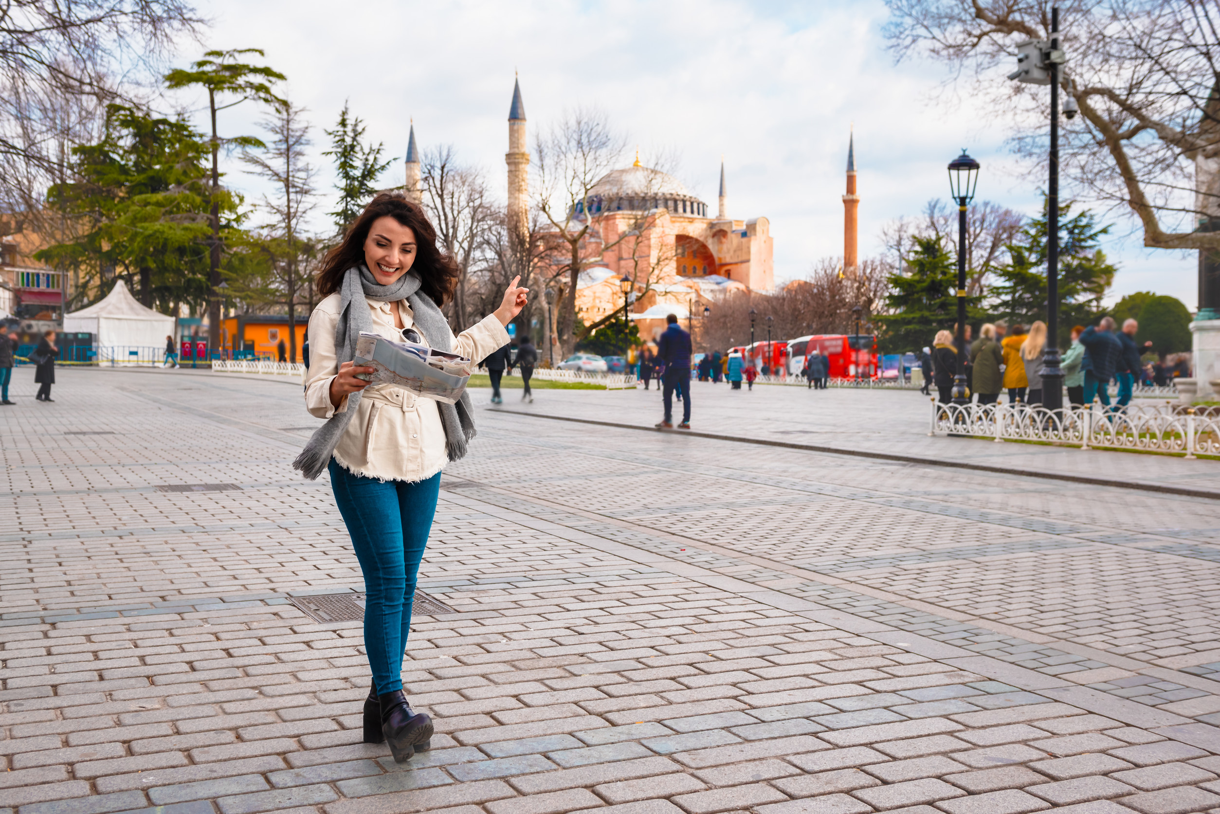 beautiful young girl in fashionable clothes with map walks around and discover city in istanbul beautiful young girl in fashionable clothes with map walks around and discover city in istanbul